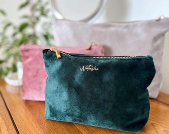 May include: Three velvet makeup bags in different colors. The green bag has the name "Natasha" embroidered on it in gold thread.