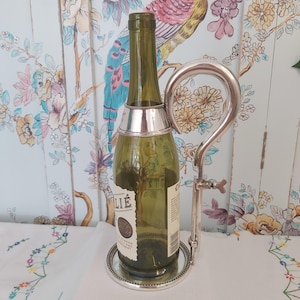 An Antique Silver Plated Wine Bottle Stand and Pourer
