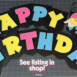 May include: A black banner with the words "HAPPY BIRTHDAY" in large, colorful letters. The letters are outlined in white and filled with pink, yellow, and blue. The banner also includes a number 6 and 7. Text at the bottom says "See listing in shop!"