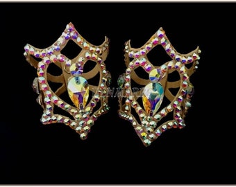 May include: A pair of gold-toned dance shoe embellishments with a geometric design and iridescent rhinestones.