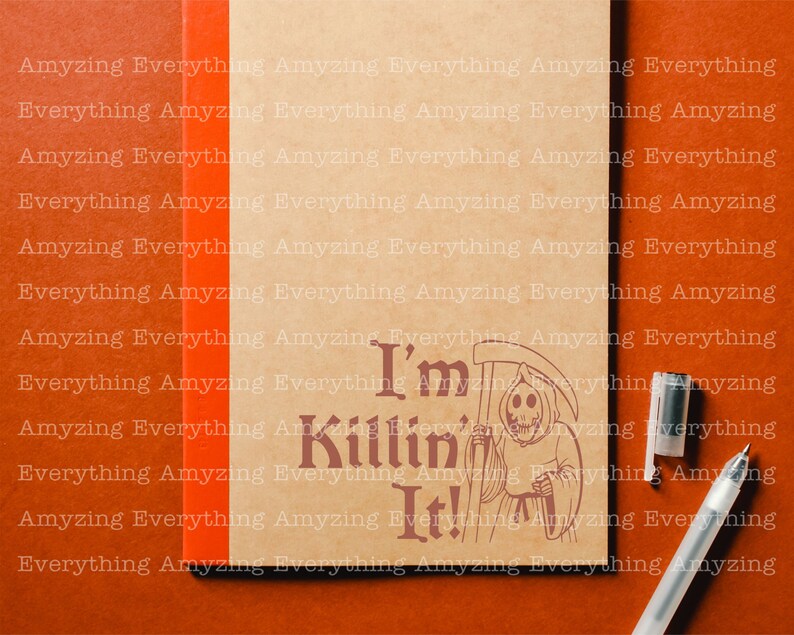 May include: A brown notebook with the text "I'm Killin' It!" printed on the front. The text is in a dark brown font and is surrounded by a black and white illustration of the Grim Reaper holding a scythe.