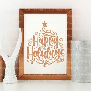 May include: A copper-coloured framed print with the text "Happy Holidays" in a decorative font. The print is on a white background and has a star at the top.