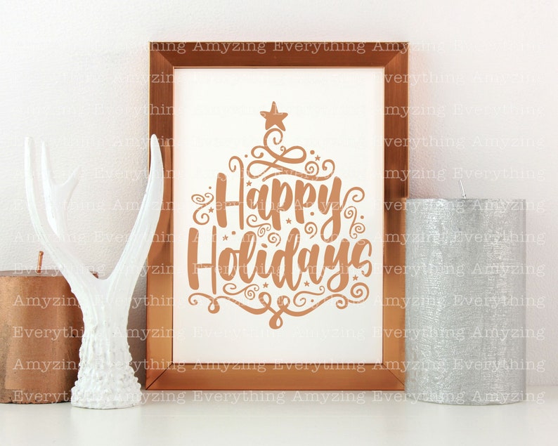 May include: A copper-coloured framed print with the text "Happy Holidays" in a decorative font. The print is on a white background and has a star at the top.