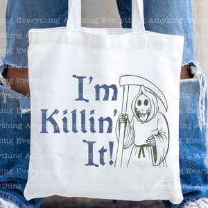 May include: White tote bag with a blue graphic that says "I'm Killin' It!" and a black and white illustration of the Grim Reaper holding a scythe.