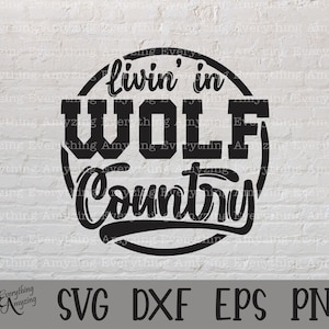 May include: Black and white graphic design with the text "livin' in WOLF Country" in a circle.