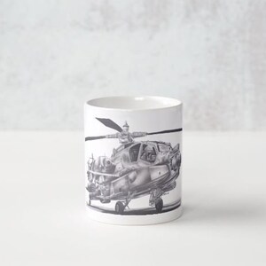 May include: White ceramic mug with a black and white illustration of a helicopter on the front.