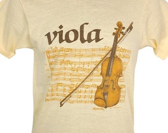 May include: A yellow t-shirt with a brown print of a violin and sheet music. The word "viola" is printed in brown above the violin.