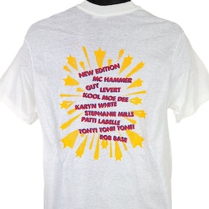 May include: White t-shirt with a yellow starburst design. The text "NEW EDITION", "MC HAMMER", "GUY LEVERT", "KOOL MOE DEE", "KARYN WHITE", "STEPHANIE MILLS", "PATTI LABELLE", "TONY! TON! TONE!" and "ROB BASE" is printed in red and blue.