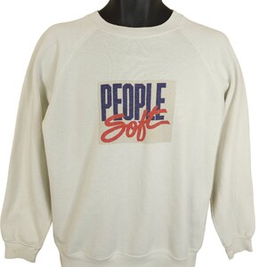 May include: White sweatshirt with a blue and red graphic print that says "PEOPLE Soft" on the front.