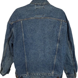 May include: A blue denim jacket with a classic design. The jacket has a button-up front, long sleeves, and two pockets on the front.