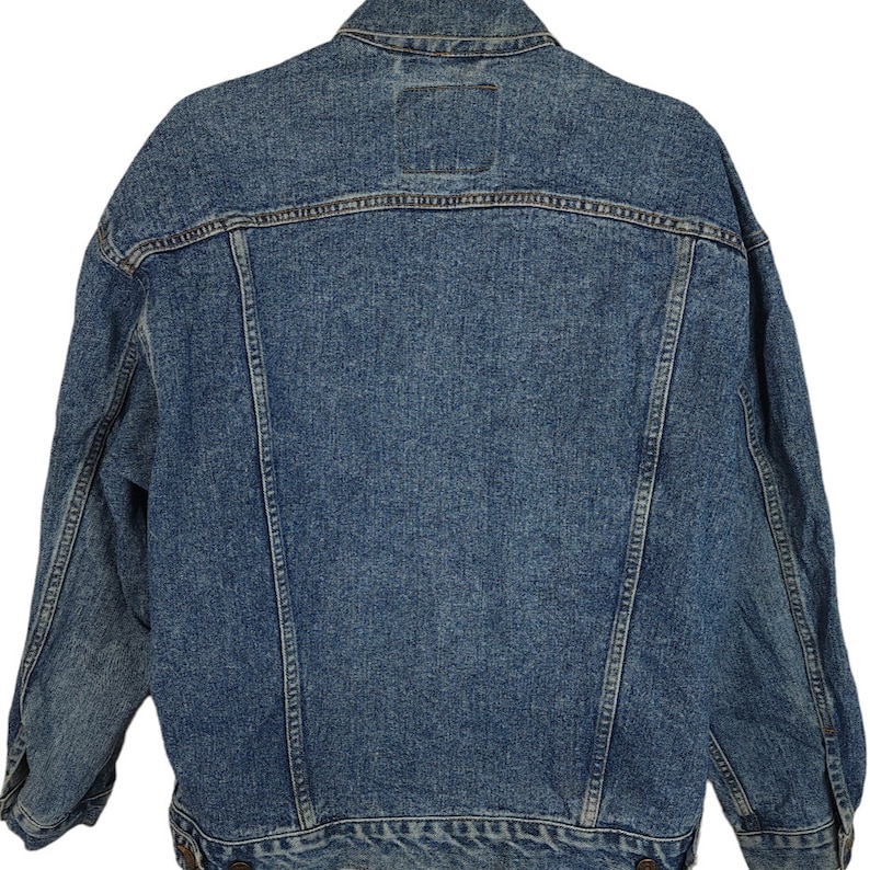 May include: A blue denim jacket with a classic design. The jacket has a button-up front, long sleeves, and two pockets on the front.