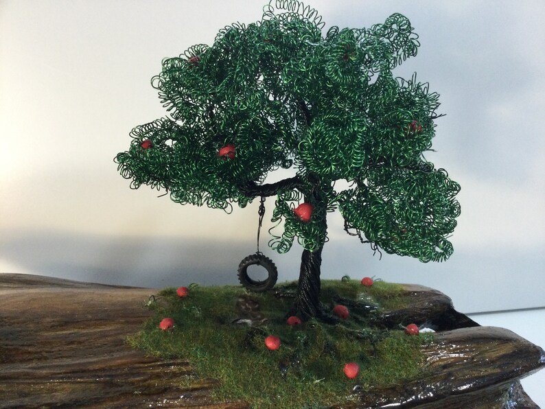 a handmade Apple wire tree Childhood Remembered\u201d \u201d A beautiful piece of driftwood and a tire swing to take us back to lazy summer days.