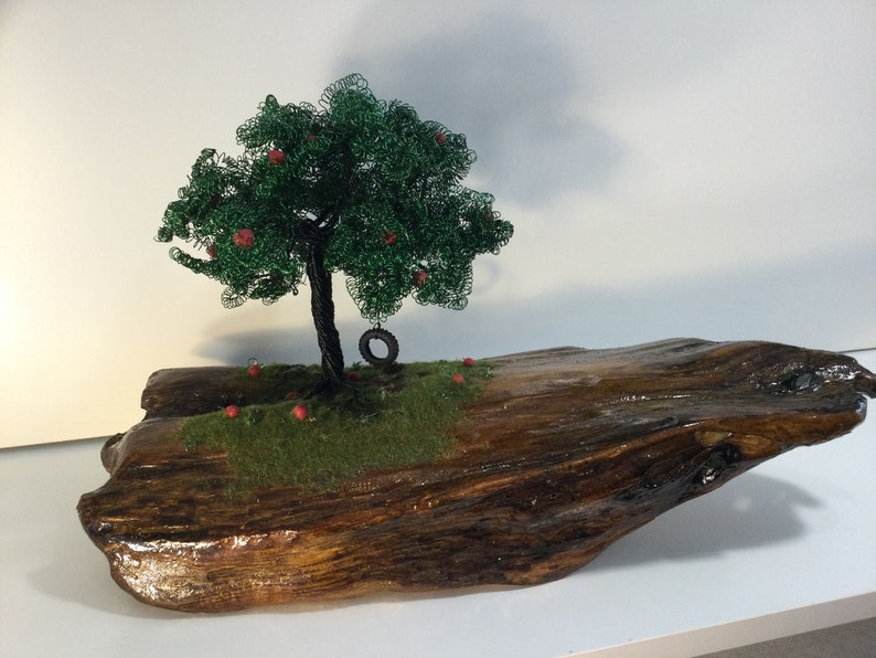 a handmade Apple wire tree Childhood Remembered\u201d \u201d A beautiful piece of driftwood and a tire swing to take us back to lazy summer days.