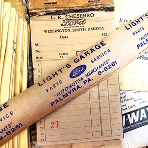 Może przedstawiać: Winietkowy brązowy rulon papieru z niebieskim tekstem, kt&oacute;ry brzmi "Light's Garage Parts "Automotive Merchants" Palmyra, PA. 8-8261". Rolka częściowo zakrywa starożytny paragon z logo Forda i tekstem "L.R. Chesebro Ford The Universal Car Wessington, South Dakota 192".