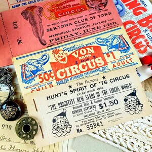 May include: Vintage circus ticket stubs with red, white, and blue colors. The tickets feature images of elephants and clowns. The text on the tickets reads "Von Bros Circus", "Hunt's Spirit of '76 Circus", and "The Brightest New Stars of the Circus World".