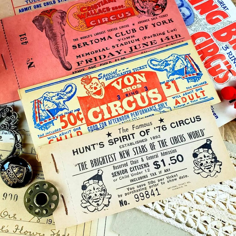 May include: Vintage circus ticket stubs with red, white, and blue colors. The tickets feature images of elephants and clowns. The text on the tickets reads "Von Bros Circus", "Hunt's Spirit of '76 Circus", and "The Brightest New Stars of the Circus World".