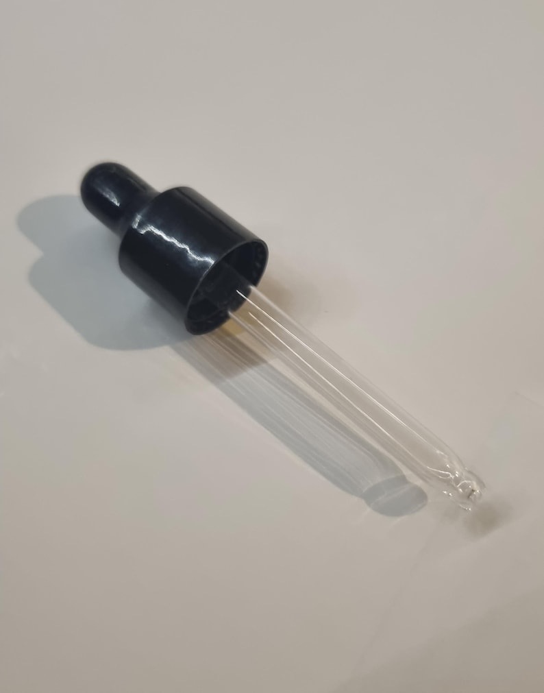 May include: A black plastic dropper bottle with a clear glass dropper. The dropper is long and thin with a pointed tip.