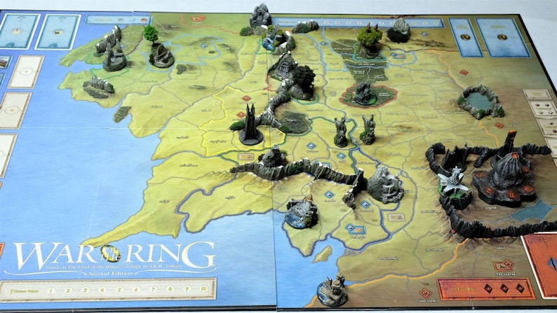 May include: A game board depicting a map of Middle-earth with miniature figures representing various locations and characters from the Lord of the Rings universe. The board game is called "Warring" and features a second edition.