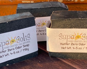 May include: Three bars of dark green soap with white labels that read "Sapo de Solis" and "Hunter Zero Odor Soap" with a net weight of 4-5 oz / 118g.