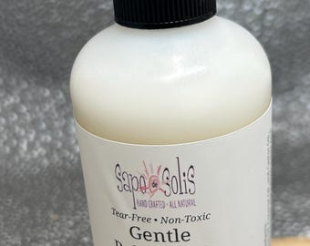 May include: A white bottle of "Gentle Baby Wash" with a black pump dispenser. The label reads "Sapo de Solis" and "Tear-Free, Non-Toxic." The bottle contains 8 fl oz (237 ml) of baby wash.