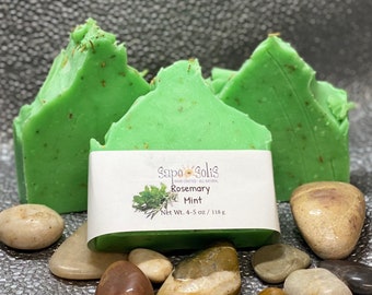 May include: Three green bars of soap with a label that reads "Sapo Solis Hand Crafted All Natural Rosemary Mint Net Wt. 4-5 oz / 118 g"