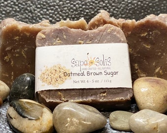 May include: Three bars of brown oatmeal and brown sugar soap with a white label that reads "Sapo Solis Hand Crafted All Natural Oatmeal Brown Sugar Net Wt 4-5 oz / 113 g".