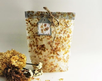 Decorative gift bag from handmade paper with real dried hydrangea flowers, eco gift wrap