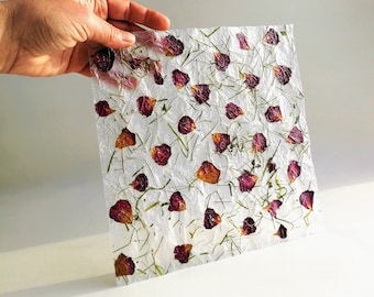 Translucent handmade thin paper with dried rose flower petals