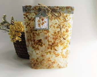 Decorative gift bag from handmade paper with real dried hydrangea flowers, eco gift wrap