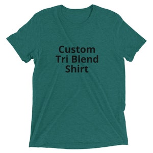 May include: A teal green t-shirt with the text "Custom Tri Blend Shirt" printed in black.