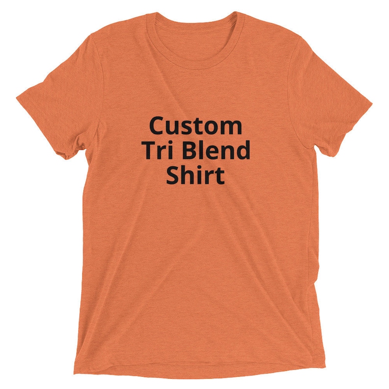 May include: A plain orange t-shirt with the text "Custom Tri Blend Shirt" printed in black.