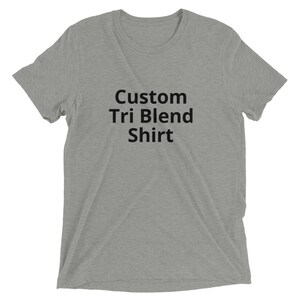 May include: A heather gray t-shirt with the text "Custom Tri Blend Shirt" printed in black.
