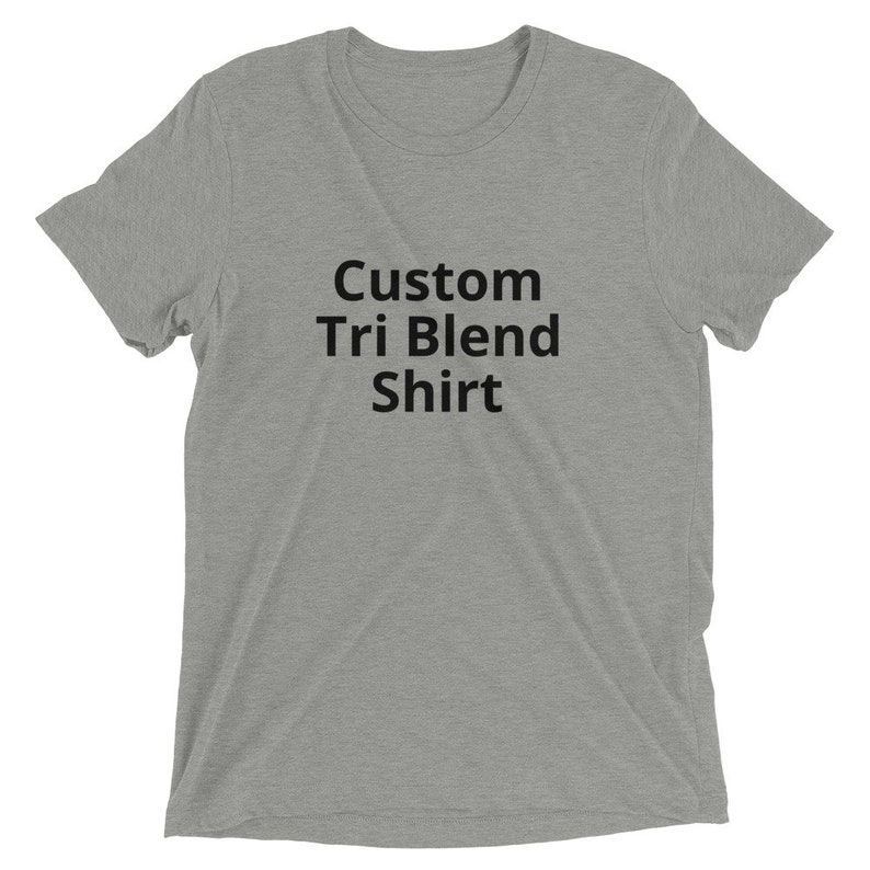 May include: A heather gray t-shirt with the text "Custom Tri Blend Shirt" printed in black.