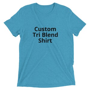 May include: A turquoise blue t-shirt with the text "Custom Tri Blend Shirt" printed in black.
