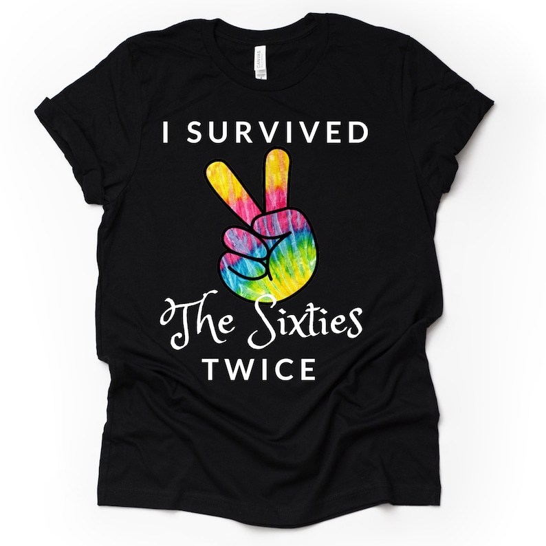 May include: Black t-shirt with a white peace sign graphic and the text "I survived the sixties twice".
