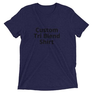 May include: A navy blue t-shirt with the text "Custom Tri Blend Shirt" printed in black.