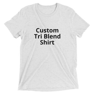 May include: A white t-shirt with the text "Custom Tri Blend Shirt" printed in black.