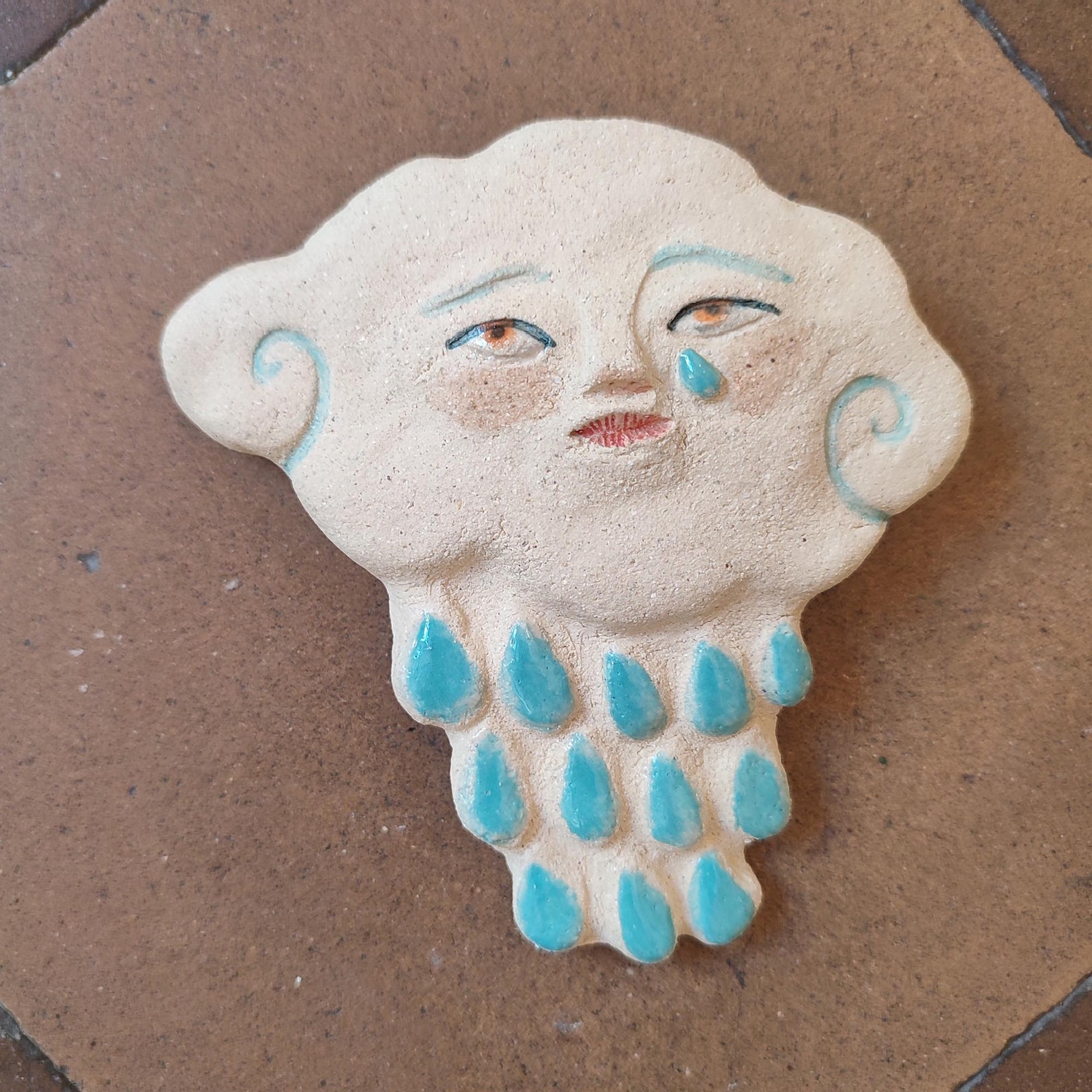 Ceramic cloud with face and raindrops, handmade wall hanging