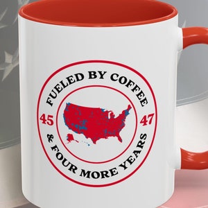 May include: White ceramic coffee mug with a red rim and handle. The mug features a red, white, and blue graphic of the United States with the text "Fueled by Coffee 45 & Four More Years 47".