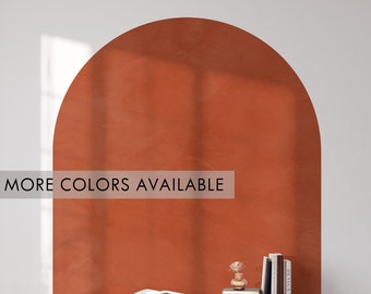 May include: A terracotta-colored arch wall decal with a wooden desk and chair in front of it. The desk has a white surface and two drawers. The chair has a black frame and a woven seat. The text "MORE COLORS AVAILABLE" is visible on the wall.