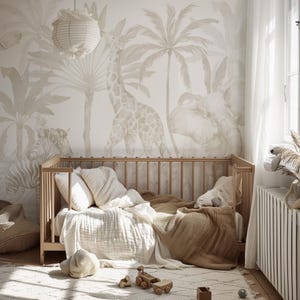 May include: A light wooden crib with white and beige bedding, positioned against a wall featuring a large-scale mural of a giraffe, elephant, and zebra in a jungle setting with palm trees, illuminated by a hanging paper lantern light fixture.