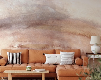 May include: A burnt orange sectional sofa with a tufted seat, featuring one white pillow with black stripes, one white pillow with black buttons, and one white pillow with grey stripes. A wooden coffee table sits in front of the sofa.