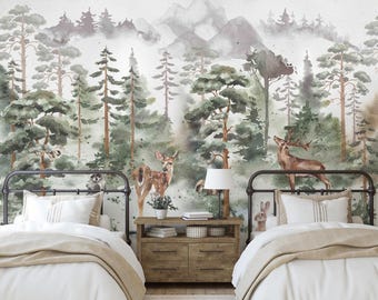 May include: A wall mural featuring a watercolor forest landscape with pine trees, mountains, a deer, and a rabbit. Two black metal bed frames with white bedding are positioned on either side of a wooden nightstand with drawers and a lamp.