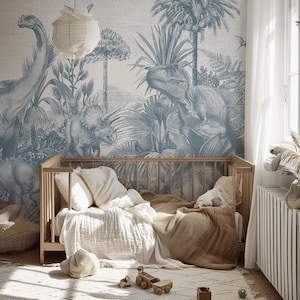 May include: A nursery with a light wood crib, soft bedding, and a dinosaur-themed mural in shades of blue and white. The room includes a rug, a paper lantern, and wooden toys, creating a cozy and playful atmosphere.