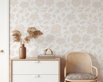 May include: A light beige wallpaper featuring a repeating pattern of soft, muted floral silhouettes. The design consists of various flower blossoms and leaves in a monochromatic tone, creating a subtle and consistent visual texture across the surface.