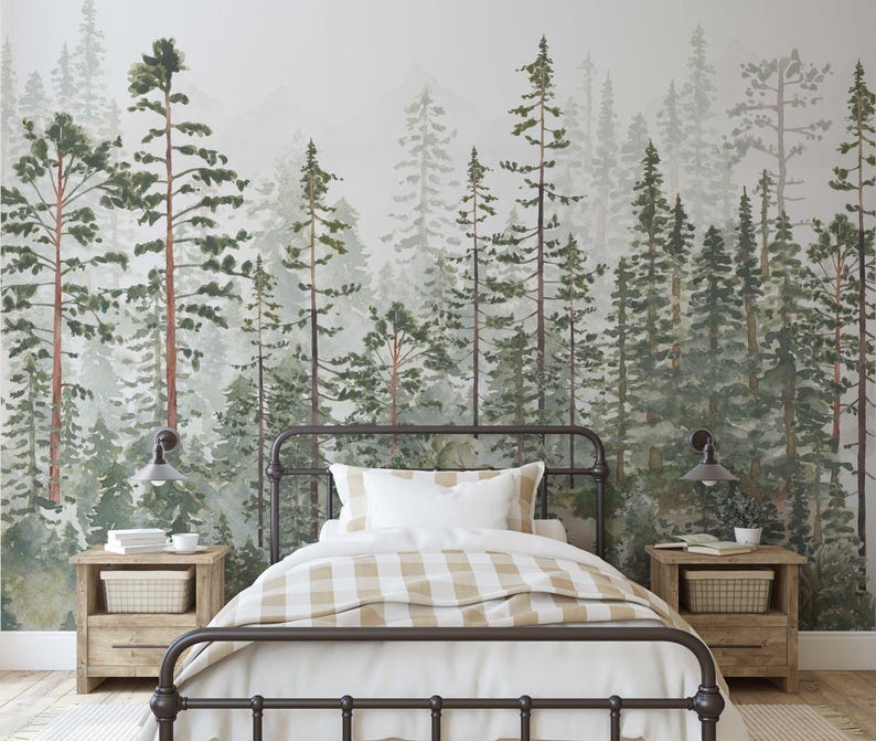 May include: A bedroom with a forest-themed mural. The bed has a dark metal frame, white bedding, and a tan and white checkered blanket. Two wooden nightstands with lamps flank the bed. The mural features watercolor trees in shades of green and brown.