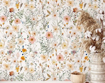 May include: Wallpaper featuring a repeating pattern of watercolor wildflowers in shades of pink, yellow, and white with green foliage. A decorative vase filled with dried cotton stems and a small wooden bowl sit in the foreground.