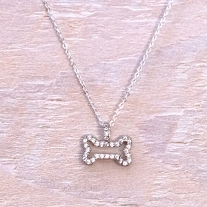 Tiny crystal dog bone pendant. Sterling silver