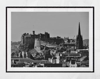 May include: A black and white photograph of Edinburgh Castle, a historic fortress located on a hilltop in Edinburgh, Scotland. The castle is a popular tourist destination and is known for its iconic architecture and rich history.