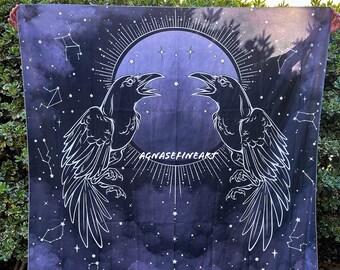 May include: A black and white tapestry with a dark blue background featuring two ravens facing each other with their wings spread. The ravens are outlined in white and have a moon and stars in the background. The text "AGNASEFINEART" is printed in white at the bottom of the tapestry.